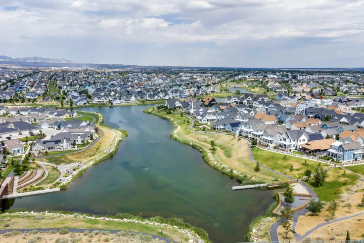 Expansive residential community featuring a central lake, extensive green spaces, and a variety of architectural styles