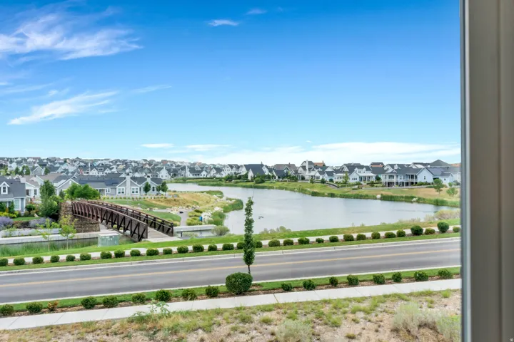 Expansive lake and neighborhood panorama visible from a large window
