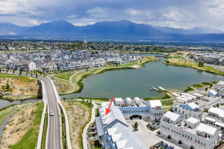 Aerial perspective showcasing a modern multi-story residential building with rooftop patios