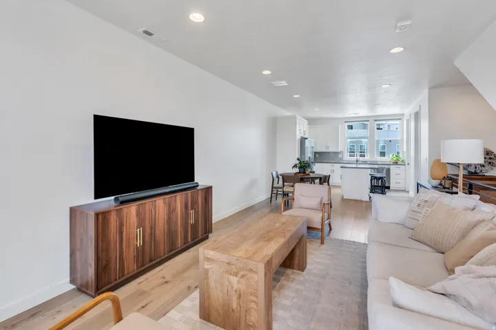 Open-concept living space featuring light wood-finish flooring throughout