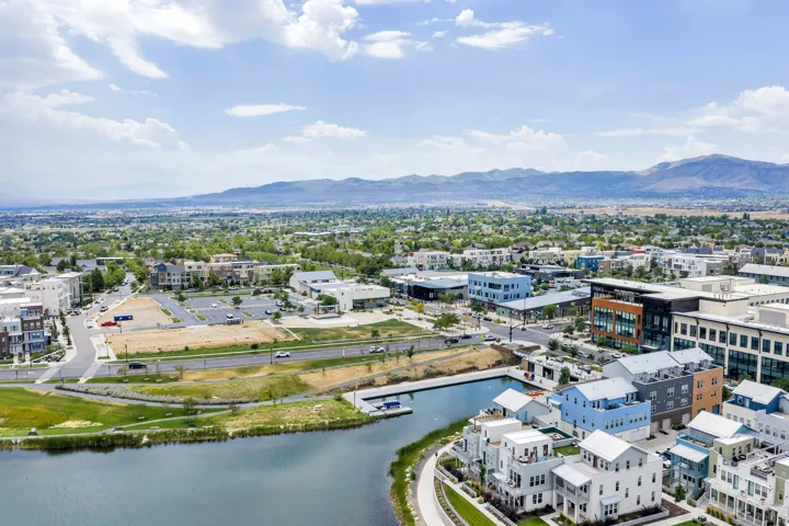 Aerial perspective showcasing a vibrant community with a prominent water feature