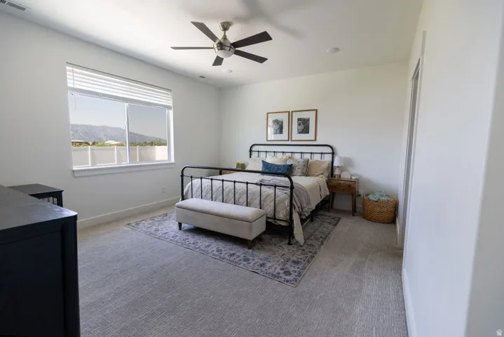 Bright room featuring a large window, recessed lighting, and a ceiling fan