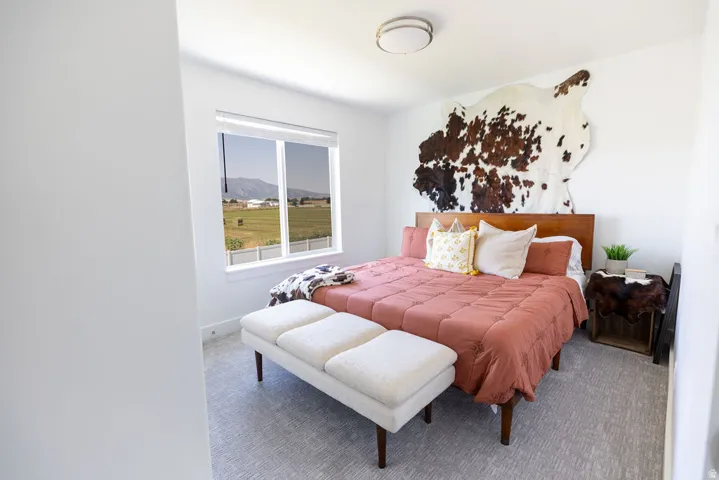 Bright room featuring a window with expansive outdoor scenery, a drum flush mount ceiling light, and textured carpet flooring