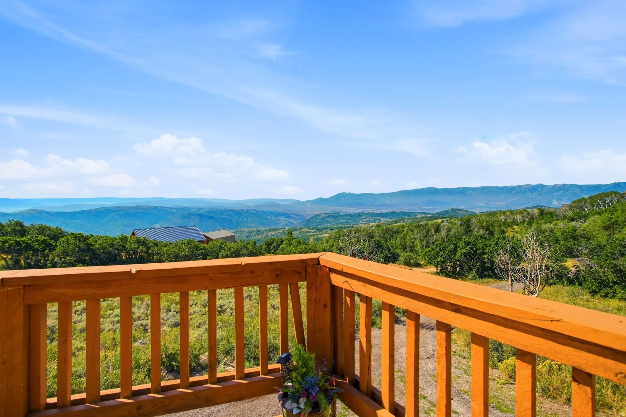 Wood-tone railing defining an outdoor deck space