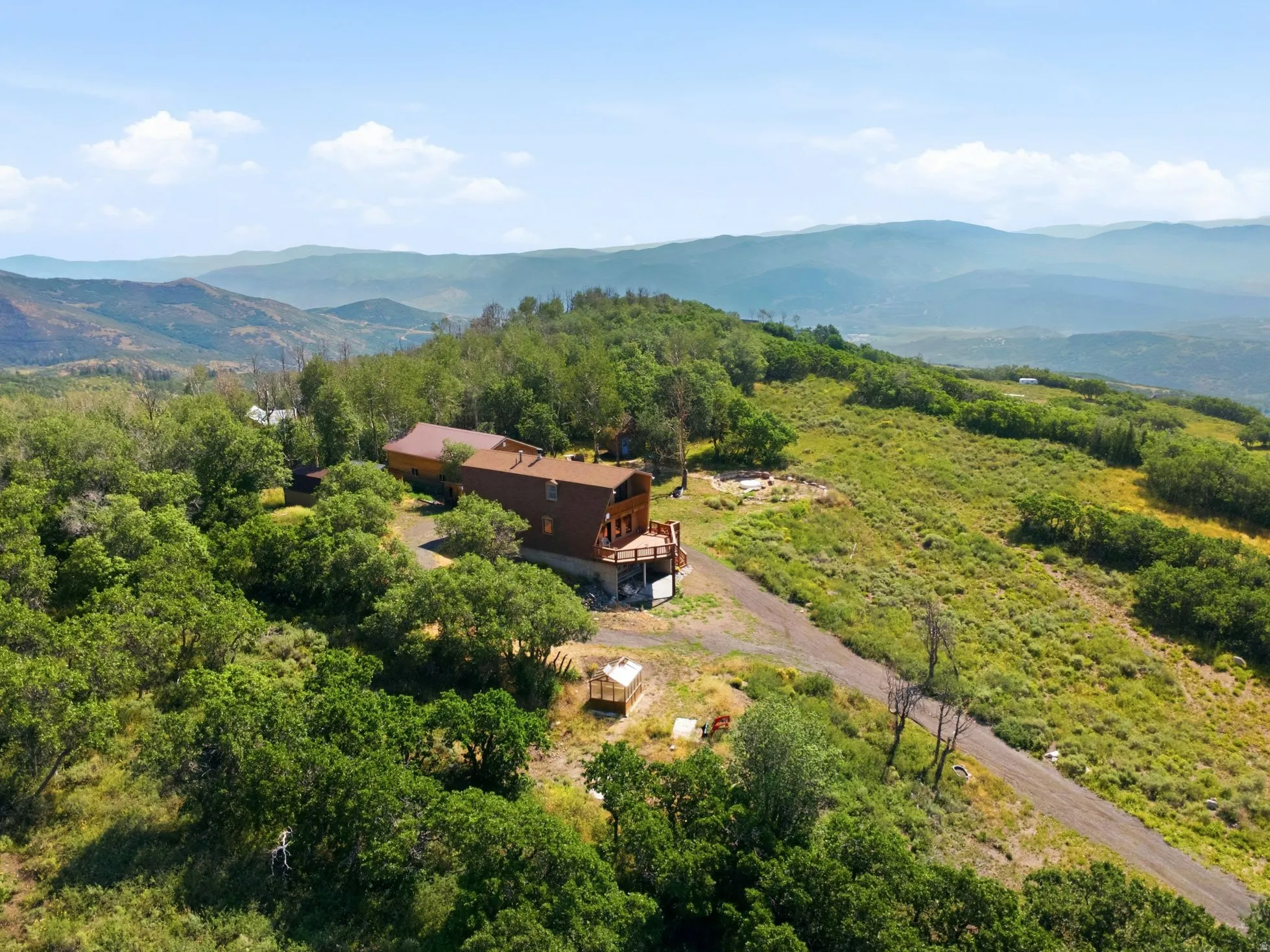 Hillside property featuring wood siding and a multi-level deck