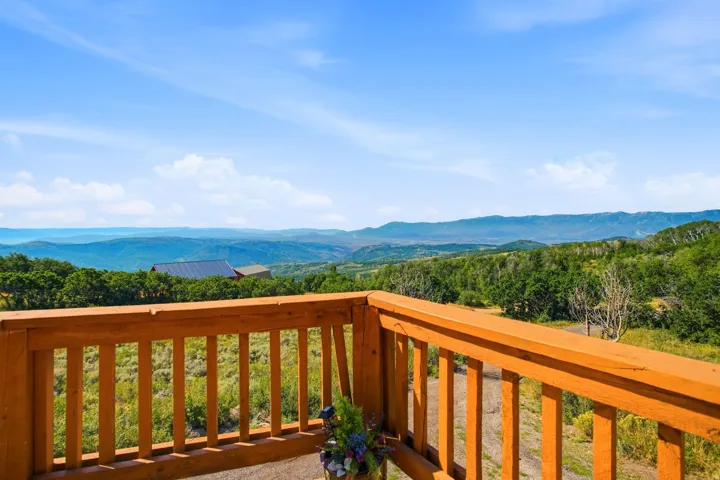 Wood-tone railing defining an outdoor deck space