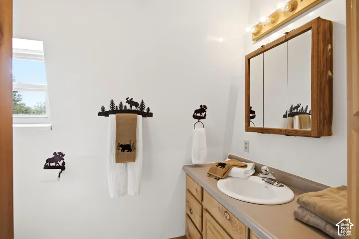 3/4 Bathroom featuring wood-finish cabinetry