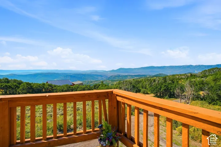 Wood-tone railing defining an outdoor deck space