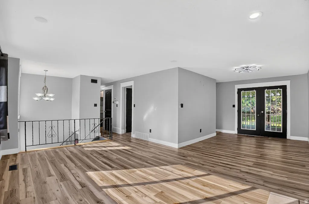 Open common area featuring wood-finish flooring, light gray wall paint, and white trim