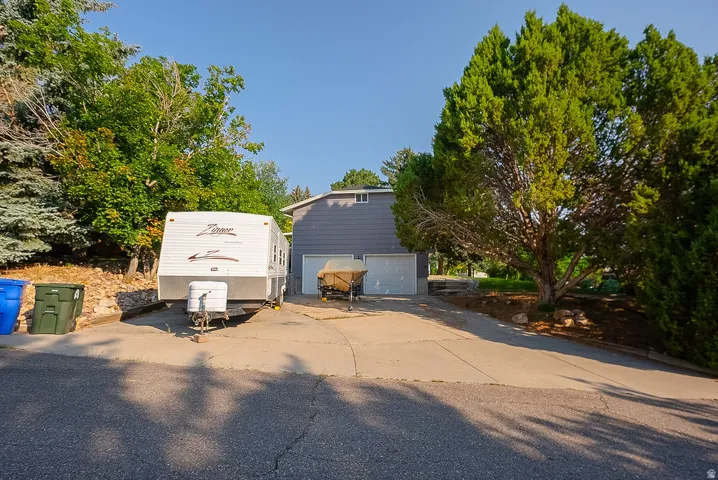 Two-car garage with white garage doors and a gray exterior