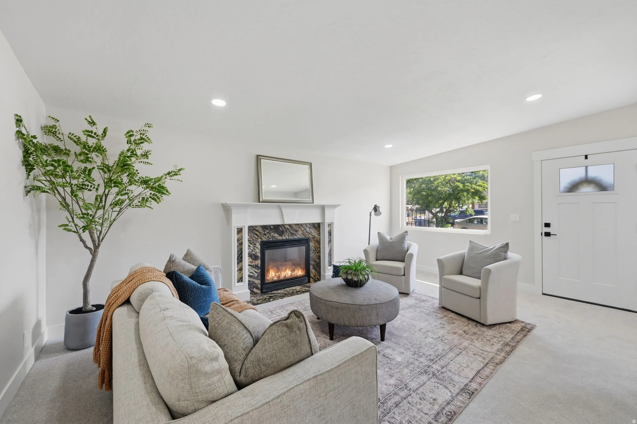 Living area featuring a fireplace with a stone surround and a white mantel