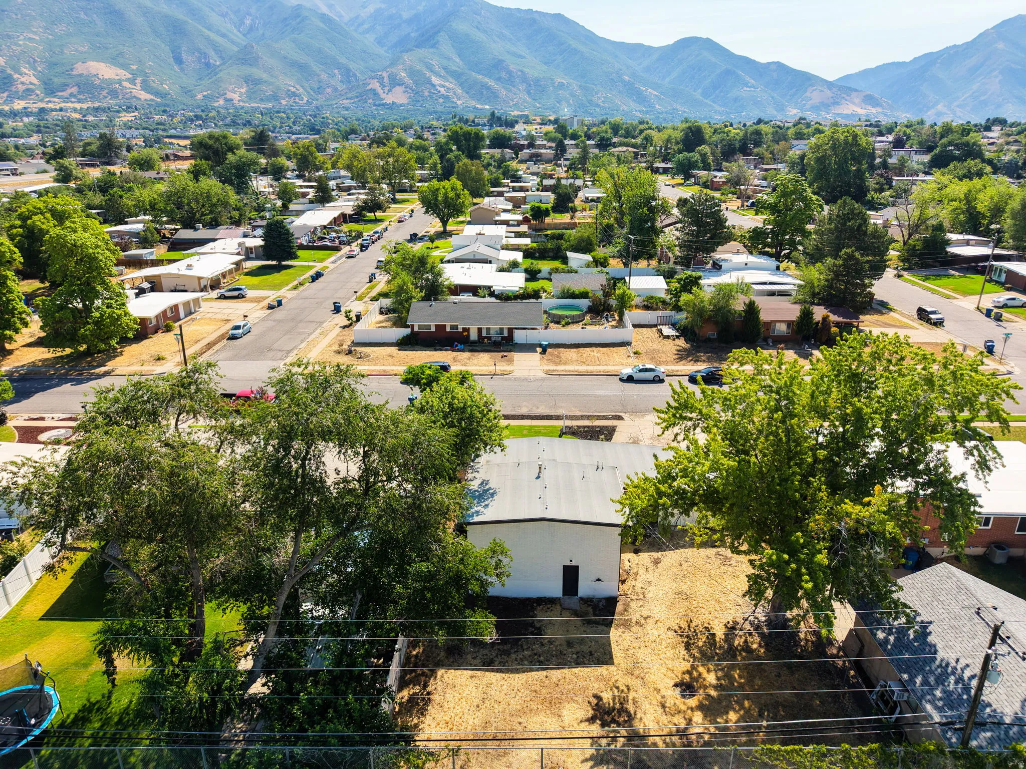 Expansive lot featuring a large, detached structure with a metal roof