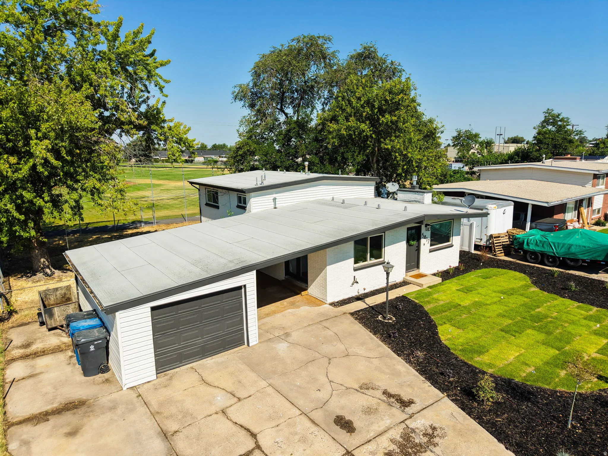 Mid-century modern residence featuring a flat roofline and integrated garage