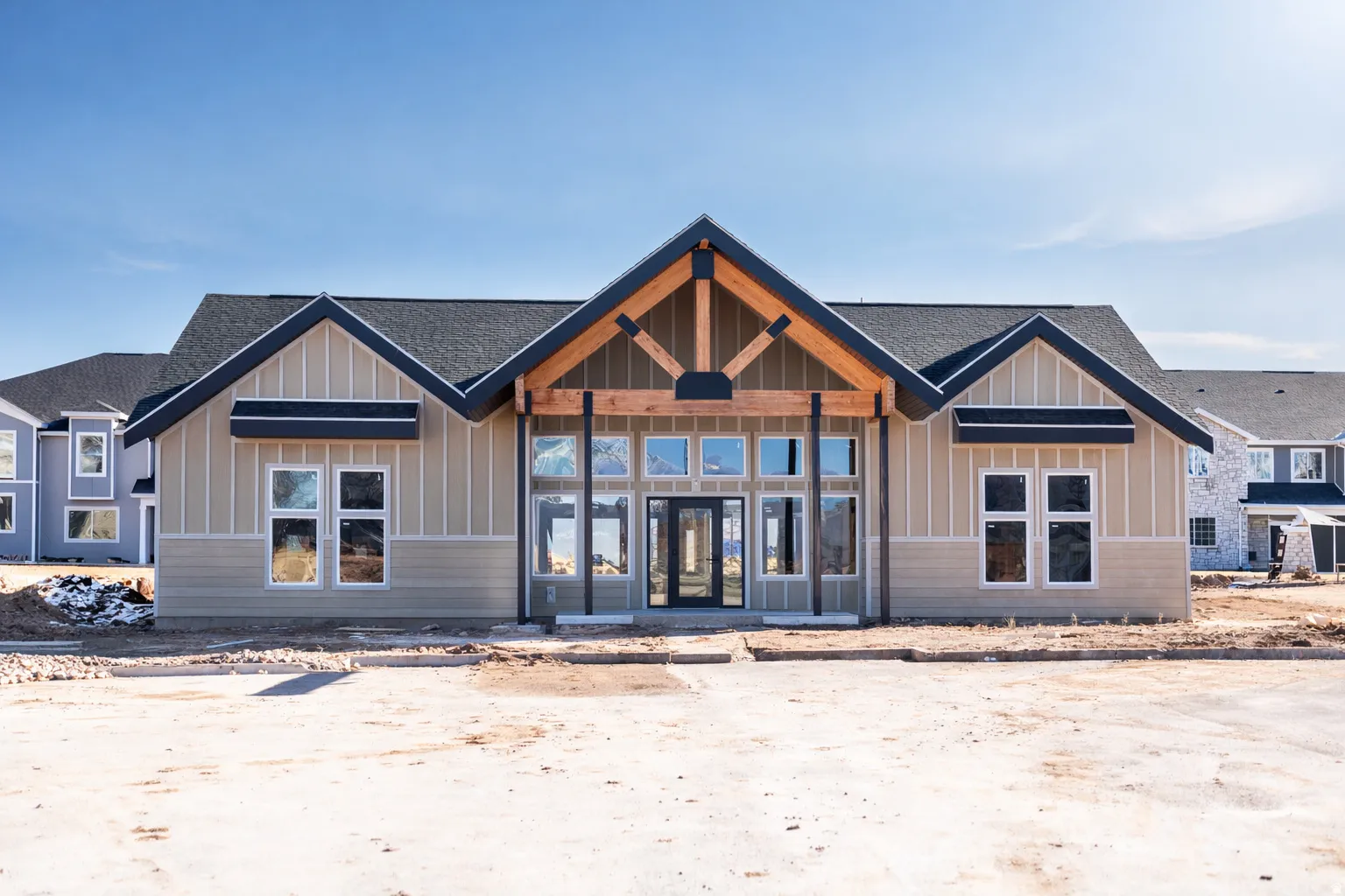 Modern craftsman-style building featuring a prominent gabled entry with exposed timber framing
