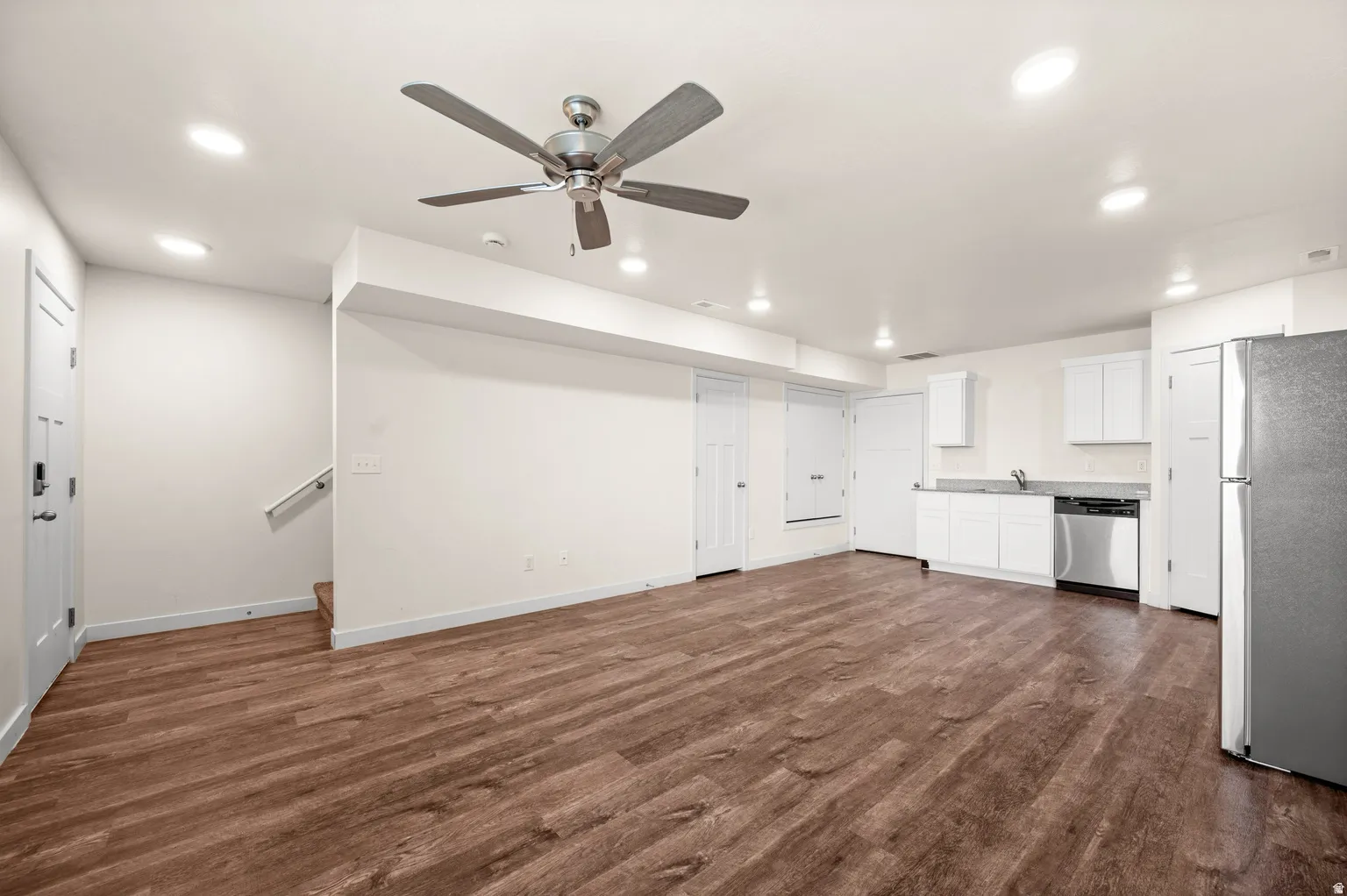Open-concept interior featuring wood-finish flooring, recessed lighting, and a ceiling fan