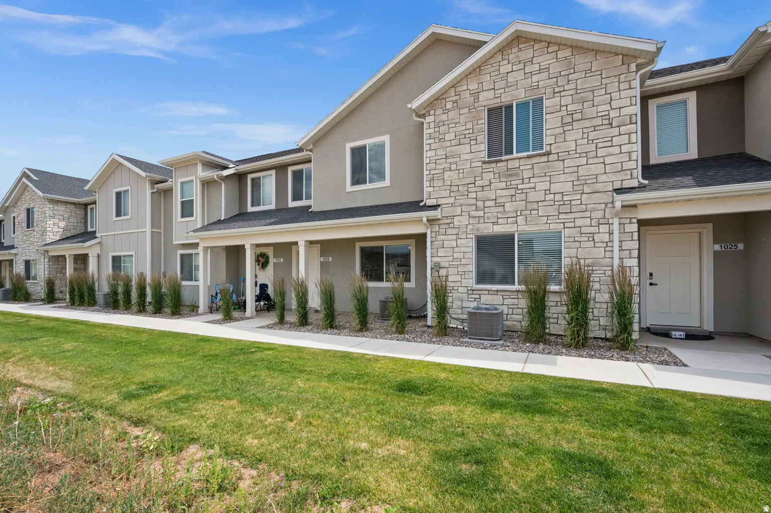 Modern townhome exterior featuring stone and stucco finishes