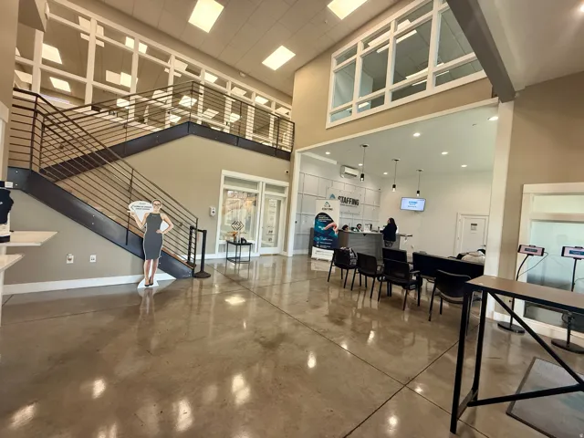Two-story open-concept entry featuring polished concrete flooring
