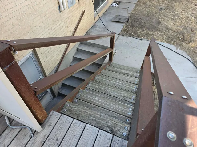 Exterior wood-finish stairs with metal railings