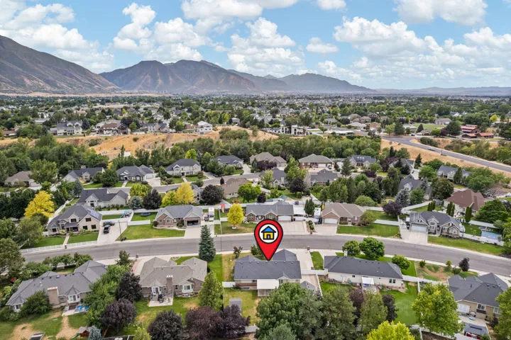 Expansive aerial view of a residential neighborhood with distant mountain ranges
