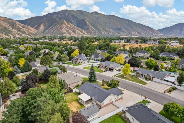 Expansive mountain backdrop framing a residential neighborhood with mature trees