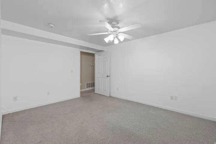 Neutral-toned carpeting and white walls define this interior space