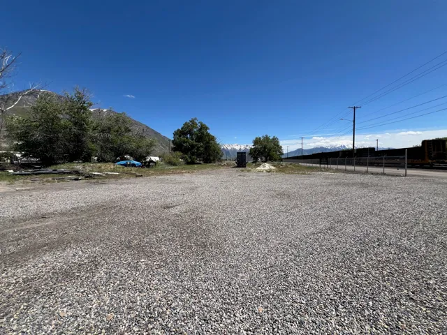 Expansive gravel lot with clear sky overhead