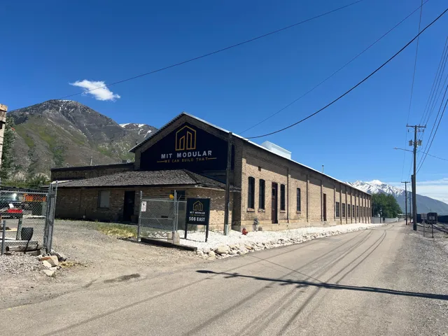 Brick-clad commercial building featuring an expansive facade with multiple tall, arched window openings