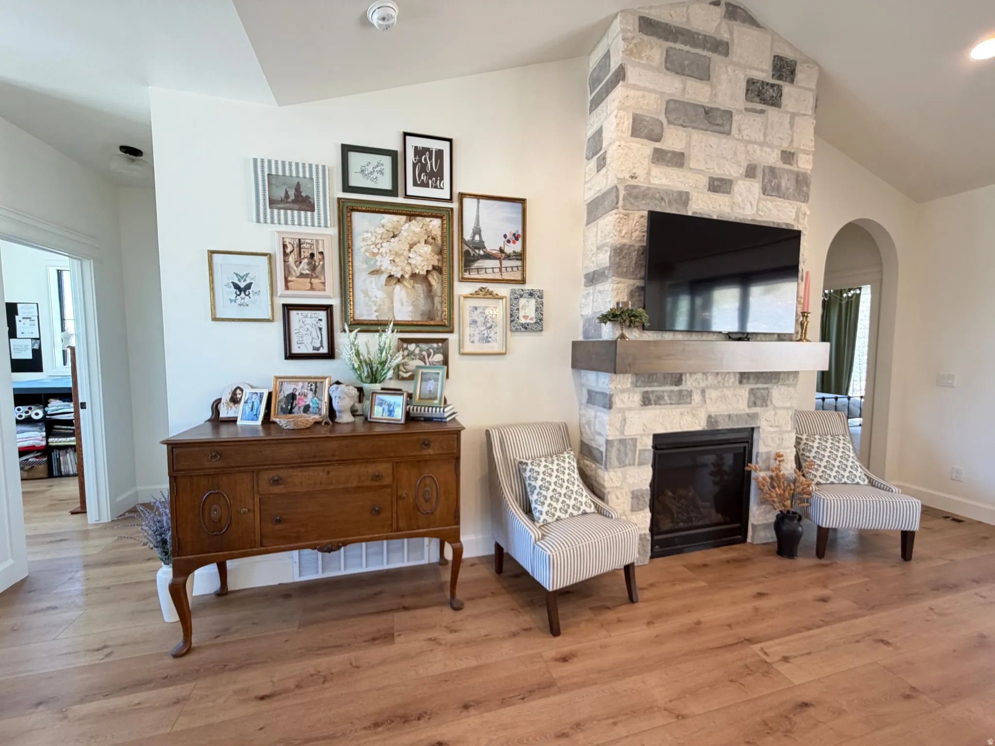 Stone-clad fireplace with a dark-tone mantel and an integrated firebox