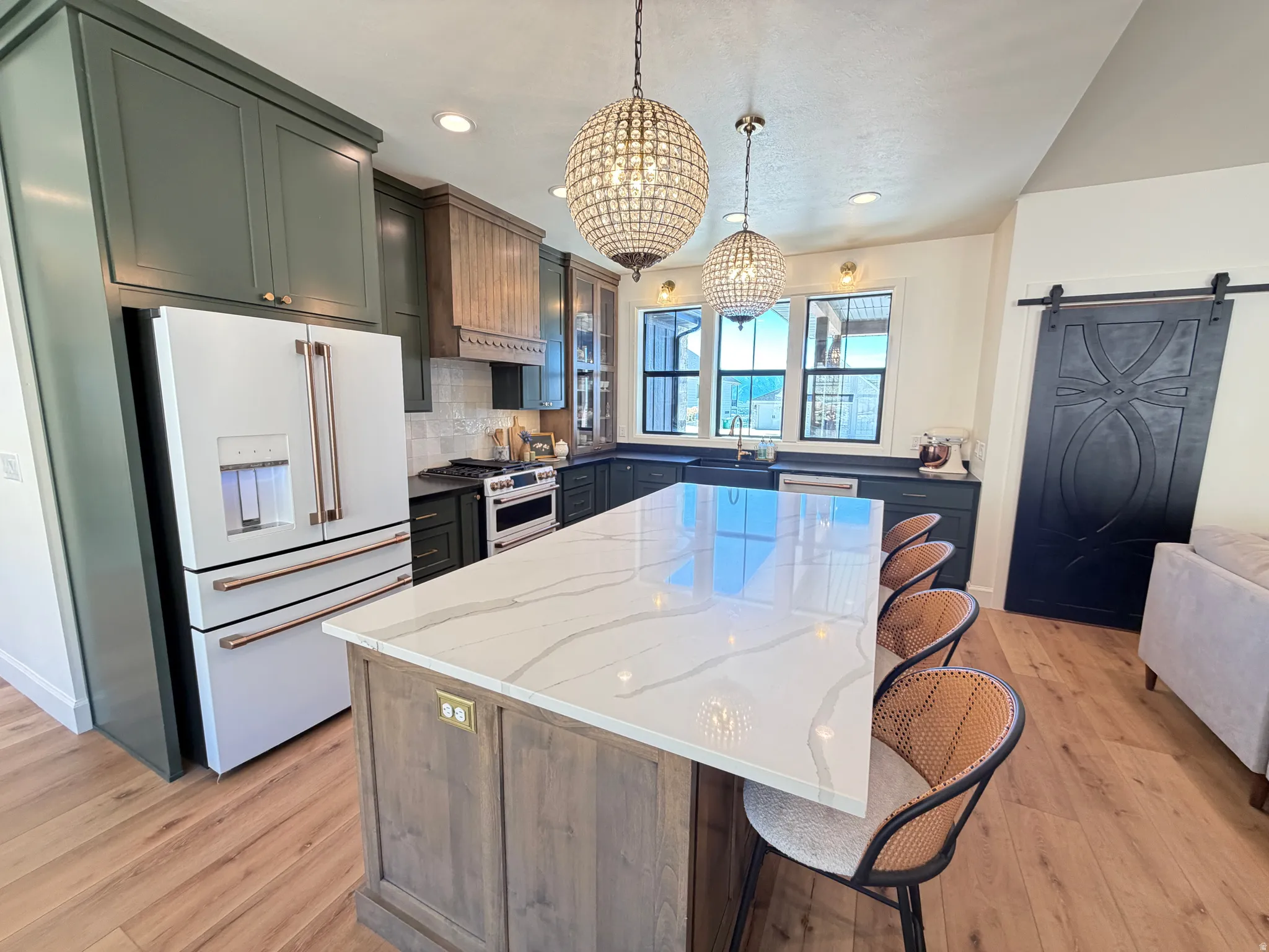 Expansive kitchen island featuring a light-toned countertop with veining