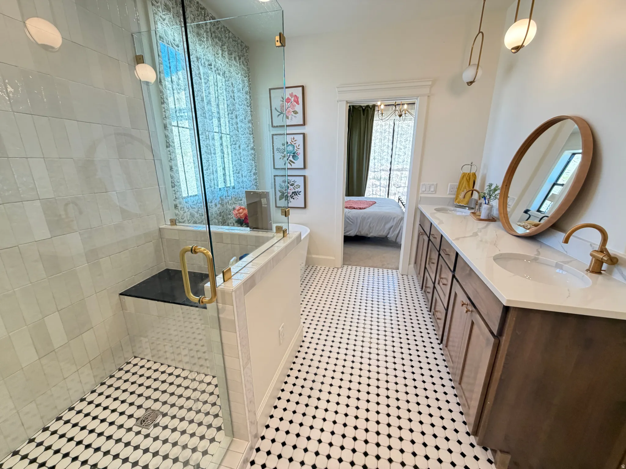 Walk-in shower with a bench, custom cabinets with a double sink and lots of storage.