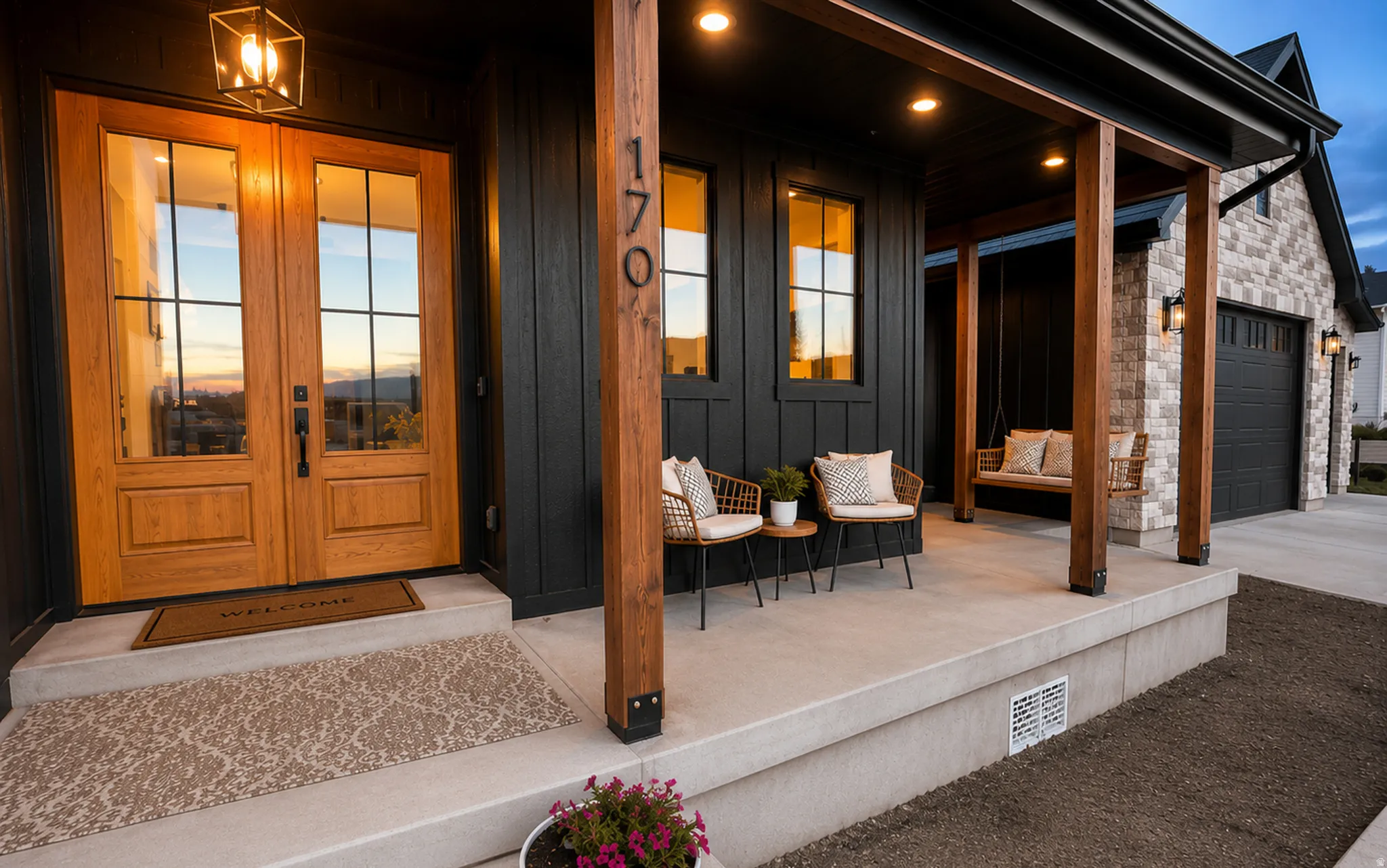 Inviting front porch featuring a double wooden entry door with glass panels, board and batten siding, stone facade, and exposed wood beams