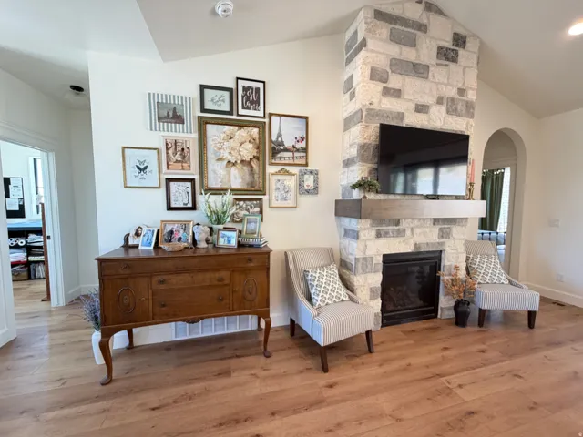 Stone-clad fireplace with a dark-tone mantel and an integrated firebox