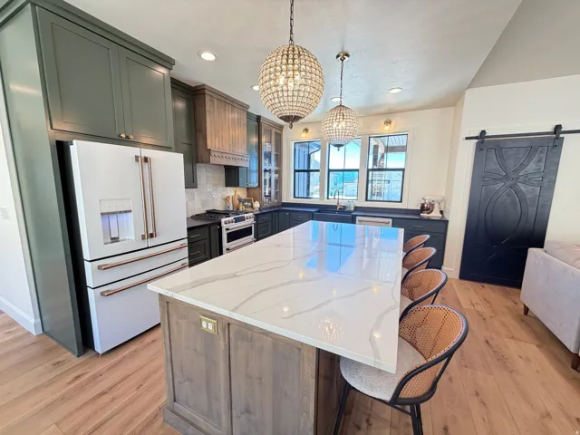 Expansive kitchen island featuring a light-toned countertop with veining