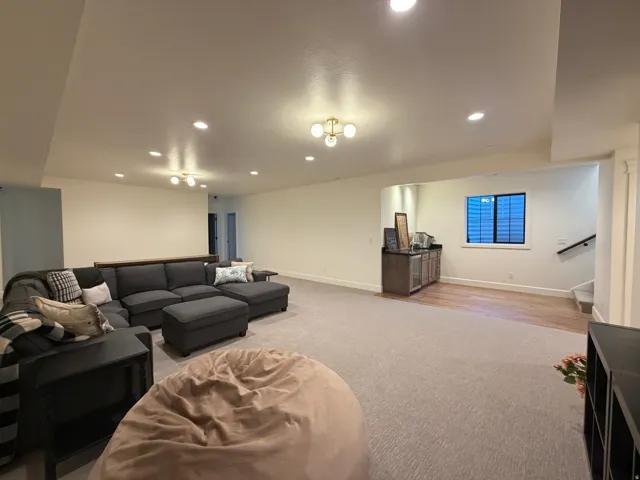 Spacious lower-level area with recessed lighting and a built-in wet bar