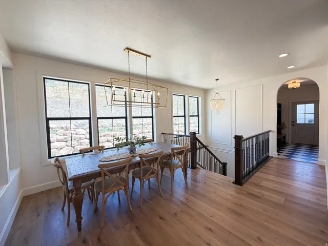 Bright dining area featuring wood-finish flooring and multiple large windows