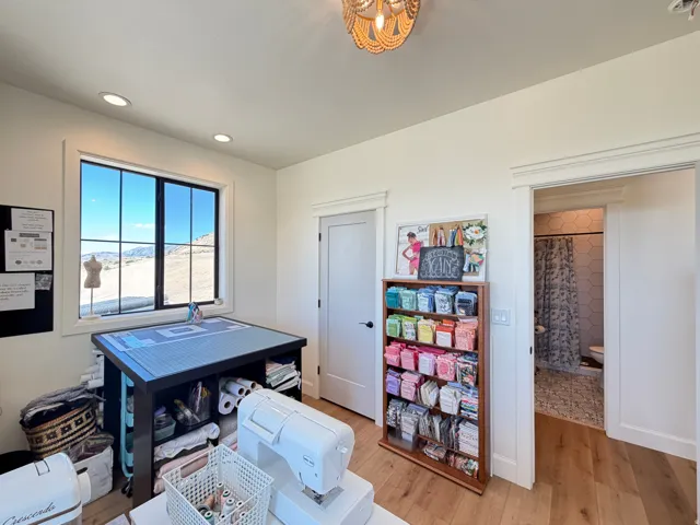 Bedroom 1, Room featuring wood-finish flooring, walk in closet and window s to the west and north with black trim
