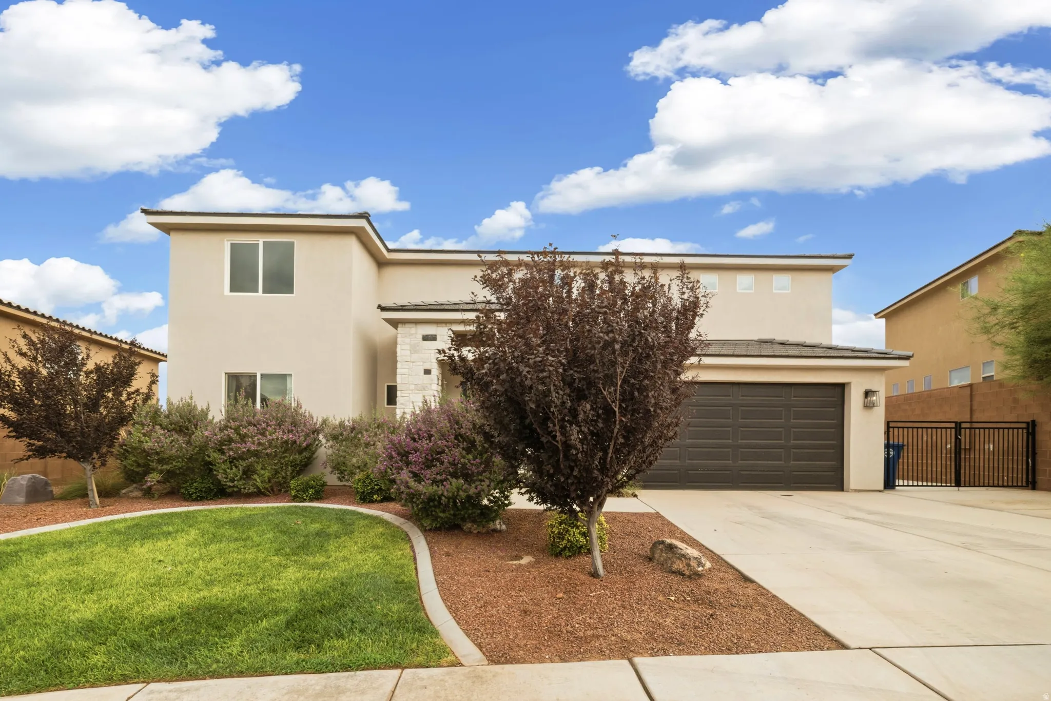 Two-story stucco exterior with a stone facade accent