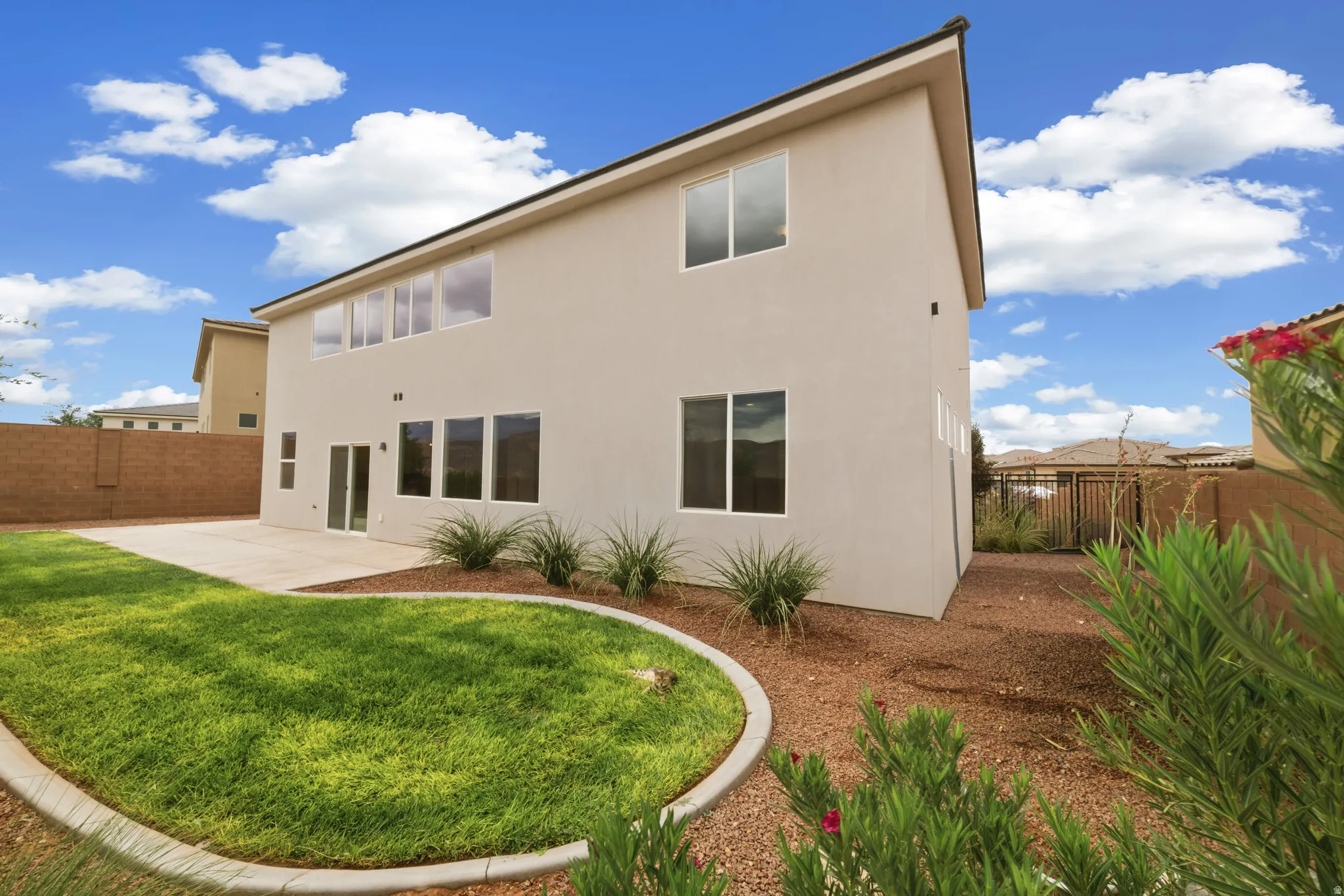 Expansive stucco exterior with multiple windows and a sliding glass door