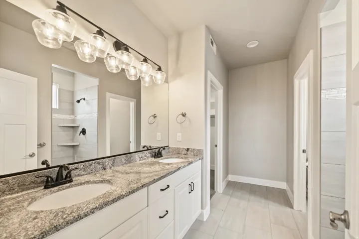 Dual vanity with stone countertop, undermount sinks, and matte black fixtures