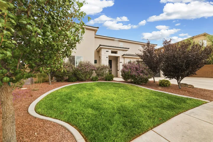 Stucco exterior with stone accents and a concrete walkway