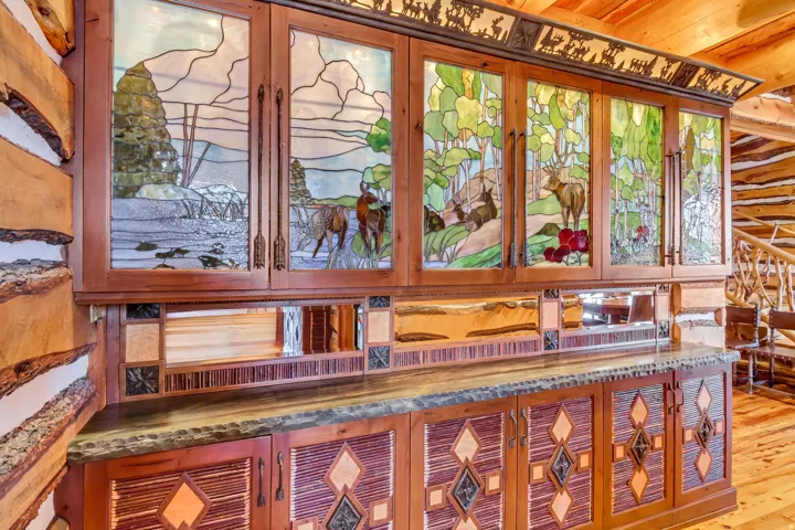 Custom built-in cabinetry featuring stained glass cabinet doors