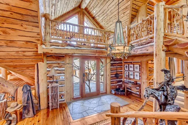 Vaulted wood-paneled ceilings with exposed log beams throughout