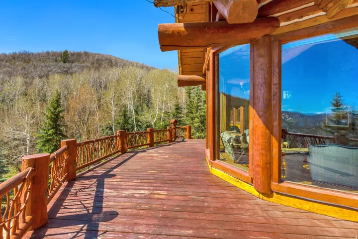 Spacious wood deck with natural branch railing