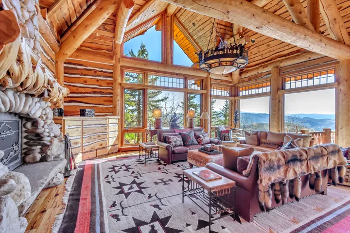 Vaulted wood-beamed ceilings with a custom chandelier and floor-to-ceiling windows