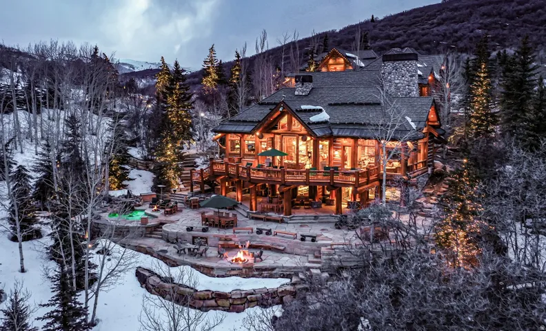Log and stone construction featuring multiple outdoor living areas