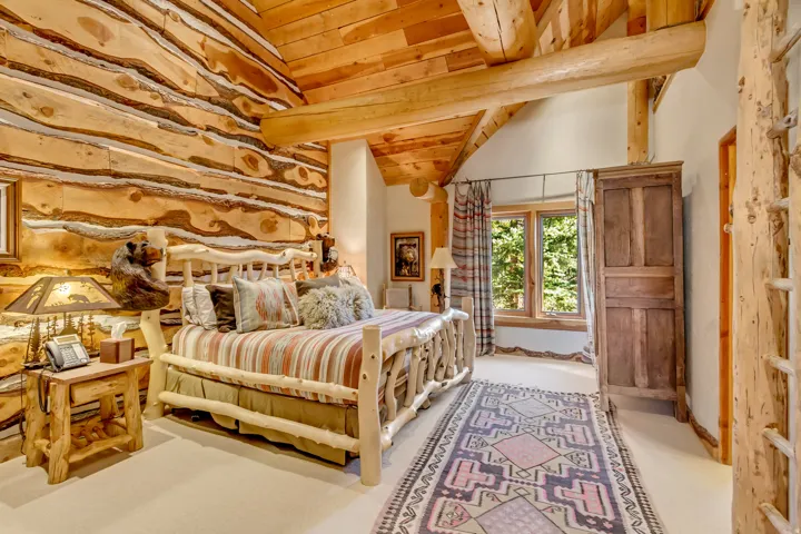 Log construction featuring exposed wood beams and natural wood paneling