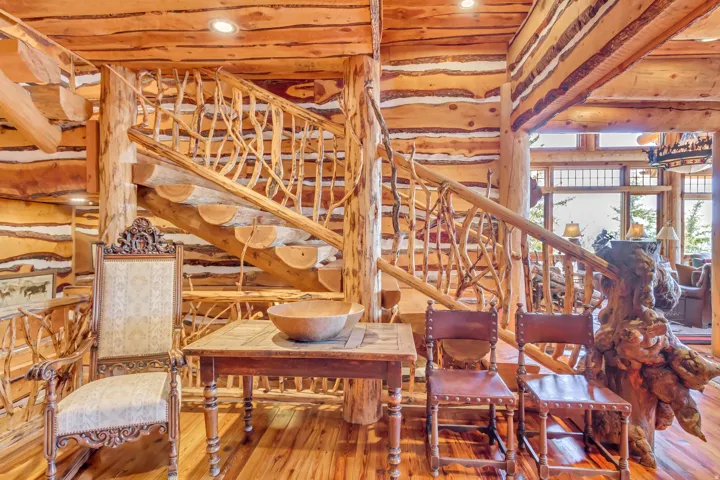 Custom log staircase featuring branch balusters and log treads