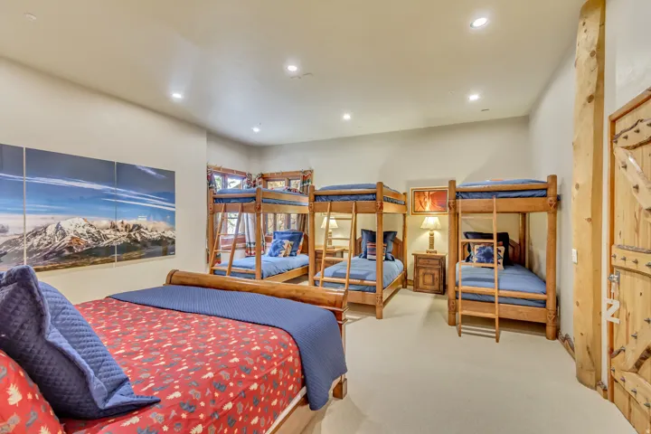 Spacious room featuring light-colored walls and carpeted flooring