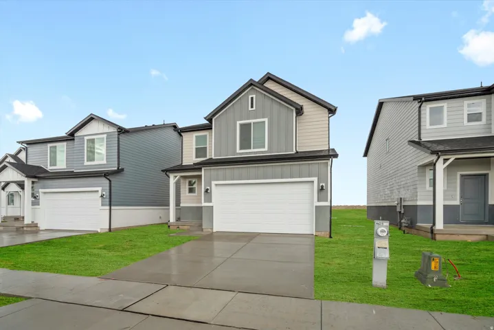 Contemporary two-story exterior with a two-tone facade, attached garage, and a concrete driveway