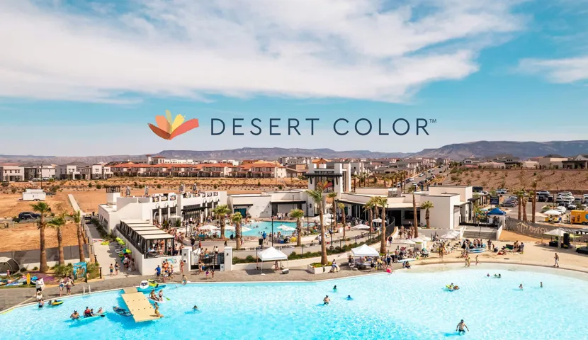 Community featuring a large water body with a sandy edge, multiple poolside structures, and numerous palm trees